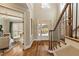 Elegant foyer featuring hardwood floors, staircase, and a glimpse into a light-filled living space at 714 Billings Farm Ln, Canton, GA 30115