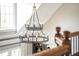 Elegant foyer with a modern chandelier, hardwood floors, and a staircase leading to the upper level at 714 Billings Farm Ln, Canton, GA 30115