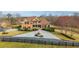 Stately brick home with manicured landscaping, fountain, and a circular driveway at 714 Billings Farm Ln, Canton, GA 30115