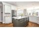 Spacious kitchen boasting white cabinets, a gray island, and stainless steel appliances at 714 Billings Farm Ln, Canton, GA 30115