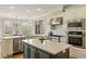 Spacious kitchen with stainless steel appliances, island, and breakfast nook with lots of windows at 714 Billings Farm Ln, Canton, GA 30115