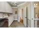 Well-lit laundry room featuring white cabinetry and modern black washing machine at 714 Billings Farm Ln, Canton, GA 30115