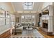 Living room with vaulted ceiling, skylight, fireplace, and backyard view at 714 Billings Farm Ln, Canton, GA 30115