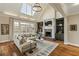 Bright living room featuring a fireplace, built-in bookshelves, and large windows at 714 Billings Farm Ln, Canton, GA 30115