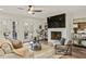 Cozy living room features a fireplace, hardwood floors, a ceiling fan, and French doors to the outside at 714 Billings Farm Ln, Canton, GA 30115