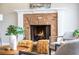 Inviting living room showcasing a brick fireplace and stylish decorative furniture at 714 Billings Farm Ln, Canton, GA 30115