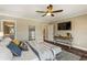 Bright main bedroom offering ample space, natural light, hardwood floors and a ceiling fan at 714 Billings Farm Ln, Canton, GA 30115