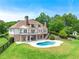Expansive rear exterior featuring a pristine in-ground pool and meticulously manicured lawn at 714 Billings Farm Ln, Canton, GA 30115