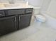 Bathroom with gray vanity, white countertop, toilet, and tub with shower at 1309 Bennett Creek Ovlk, Suwanee, GA 30024