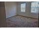 Bright bedroom with neutral carpet, white walls, and two large windows at 1309 Bennett Creek Ovlk, Suwanee, GA 30024