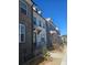 Charming townhome exterior with brick and white facade and well-maintained landscaping at 1309 Bennett Creek Ovlk, Suwanee, GA 30024
