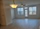 Bright living room featuring lots of natural light with stylish light fixtures and contemporary flooring at 1309 Bennett Creek Ovlk, Suwanee, GA 30024