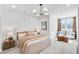 Serene bedroom showcases a paneled accent wall, plush bedding, natural light, and stylish furnishings at 208 Village Overlook # J3, Canton, GA 30114