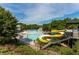 Expansive community pool area featuring winding slides, water features, and comfortable lounging spaces at 208 Village Overlook # J3, Canton, GA 30114