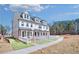 Charming new construction townhome showcasing brick accents and white picket fence at 208 Village Overlook # J3, Canton, GA 30114