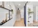 Hallway with stylish shelves, sliding barn door, and modern staircase at 208 Village Overlook # J3, Canton, GA 30114