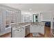 Bright kitchen with white cabinets, stainless steel appliances, granite counters, and hardwood floors at 2995 Barimore, Dacula, GA 30019