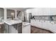 Well-lit kitchen with stainless steel appliances, granite countertops, white cabinets, and hardwood floors at 2995 Barimore, Dacula, GA 30019