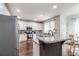 Bright kitchen features stainless appliances, white cabinets, granite counters, and a breakfast nook at 2995 Barimore, Dacula, GA 30019