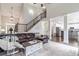 Spacious living room with staircase, open kitchen, and large windows filling the area with natural light at 2995 Barimore, Dacula, GA 30019