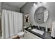 Bathroom with shower featuring a shower curtain, granite countertop and circular mirror at 3350 Vista Creek Dr, Dacula, GA 30019