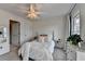 Bright bedroom with a soft color palette, complemented by a modern chandelier and plush bedding at 3350 Vista Creek Dr, Dacula, GA 30019
