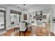 Beautiful dining area featuring hardwood flooring, modern light fixture, and view to the living room at 3350 Vista Creek Dr, Dacula, GA 30019