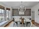 Elegant dining room with chandelier, bay window and decorative wood wall at 3350 Vista Creek Dr, Dacula, GA 30019