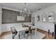 Stylish dining room featuring a chandelier, wood accent wall and modern furniture at 3350 Vista Creek Dr, Dacula, GA 30019
