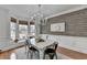 Elegant dining room with chandelier, bay window and decorative wood wall at 3350 Vista Creek Dr, Dacula, GA 30019