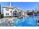 Stately home exterior with large windows overlooking the in-ground pool and beautifully landscaped backyard at 3350 Vista Creek Dr, Dacula, GA 30019
