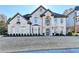 Stunning two-story brick home featuring a manicured lawn and symmetrical landscaping at 3350 Vista Creek Dr, Dacula, GA 30019