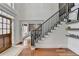Welcoming foyer with hardwood floors, staircase with black wrought iron spindles and bright light at 3350 Vista Creek Dr, Dacula, GA 30019