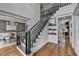 Bright, airy foyer with hardwood floors and staircase with black wrought iron spindles at 3350 Vista Creek Dr, Dacula, GA 30019
