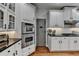 Chef's kitchen boasts stainless steel appliances and modern white cabinets at 3350 Vista Creek Dr, Dacula, GA 30019