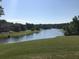 Scenic view of a serene lake surrounded by lush greenery and residential homes at 3350 Vista Creek Dr, Dacula, GA 30019