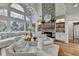 Elegant living room with stone fireplace, built-in shelving, large windows, and comfortable seating at 3350 Vista Creek Dr, Dacula, GA 30019