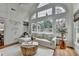 Bright living room featuring large windows, vaulted ceiling, view of the pool, and modern decor at 3350 Vista Creek Dr, Dacula, GA 30019
