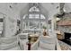 Bright living room with vaulted ceilings, large windows overlooking the pool, and comfortable white sofas at 3350 Vista Creek Dr, Dacula, GA 30019