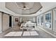 The bright main bedroom features a tray ceiling, neutral tones, and large windows with natural light at 3350 Vista Creek Dr, Dacula, GA 30019