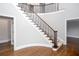 Grand foyer showcasing a curved staircase with wood and iron detailing at 4811 Cross Creek Ct, Kennesaw, GA 30152