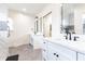 Bright bathroom with dual sink vanities and a step-in shower with decorative tile accents at 1511 Womack Rd, Atlanta, GA 30338