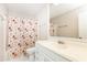 Simple bathroom features a vanity with floral shower curtain at 1511 Womack Rd, Atlanta, GA 30338