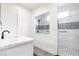 Bright bathroom featuring a step-in shower with decorative tile accents and a stylish single sink vanity at 1511 Womack Rd, Atlanta, GA 30338