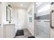 Bright bathroom featuring a step-in shower with decorative tile accents and a sleek single sink vanity at 1511 Womack Rd, Atlanta, GA 30338