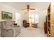 Comfortable bedroom with two upholstered recliner chairs, a ceiling fan, and neutral carpet at 1511 Womack Rd, Atlanta, GA 30338