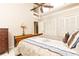 Bright bedroom featuring a ceiling fan, a cozy bed, and closet doors at 1511 Womack Rd, Atlanta, GA 30338