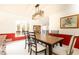 Bright dining room with a wood table, light fixture, and red accent wall at 1511 Womack Rd, Atlanta, GA 30338