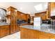 Traditional kitchen with dark wood cabinetry, granite counters, and a stone accent wall in the breakfast nook at 1511 Womack Rd, Atlanta, GA 30338