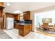 A charming kitchen featuring dark wood cabinets, granite countertops, and a view into the breakfast nook at 1511 Womack Rd, Atlanta, GA 30338